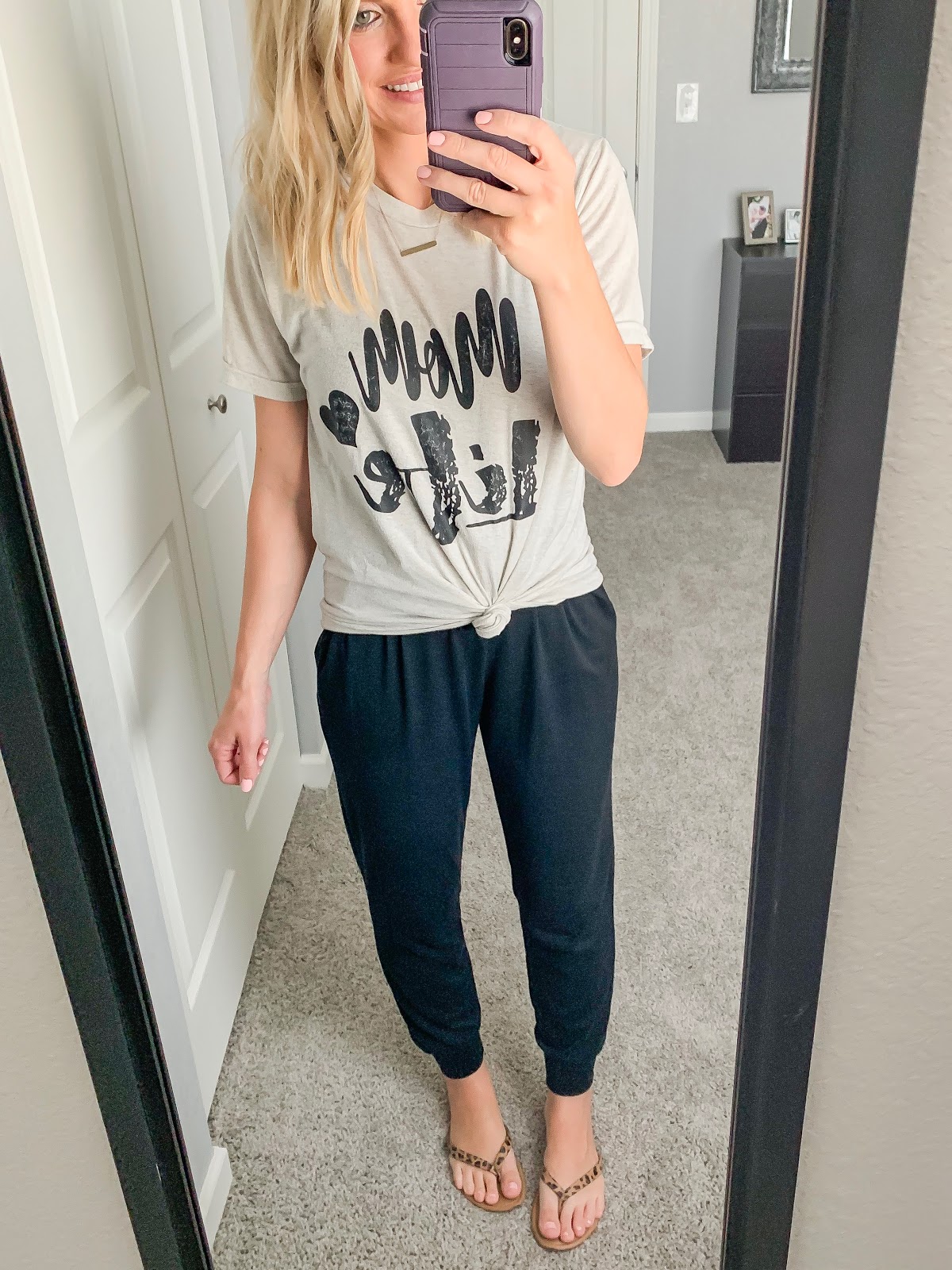 Black jumpsuit styled with a graphic t-shirt 