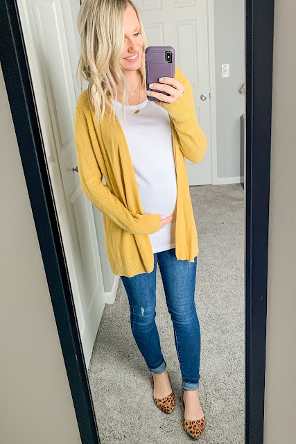 Maternity outfit with a yellow cardigan and leopard shoes