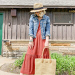Red dress styled with a denim jacket