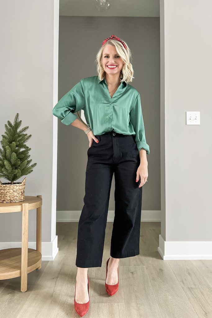 Green satin shirt with black wide leg pants and red heels.