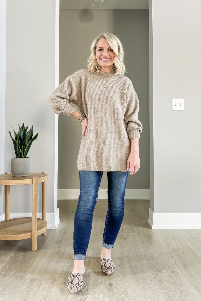 oversized sweater with skinny jeans and snakeskin mules.