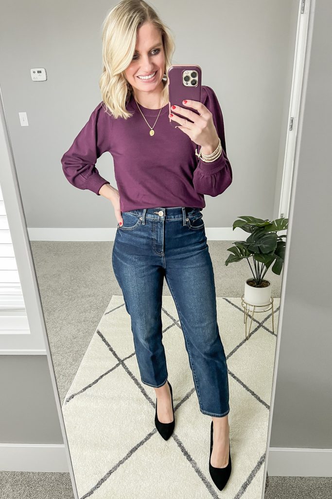 Dark straight leg jeans with purple sweater