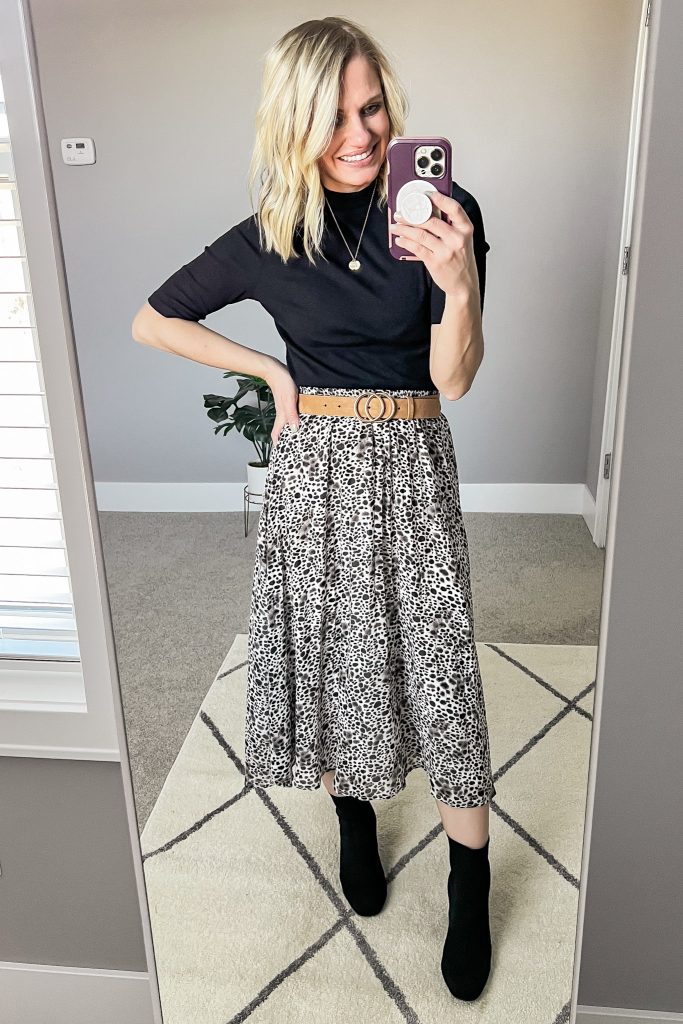 Leopard pleated skirt with black turtleneck.