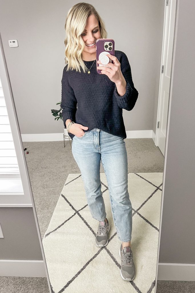 Black sweater and light jeans