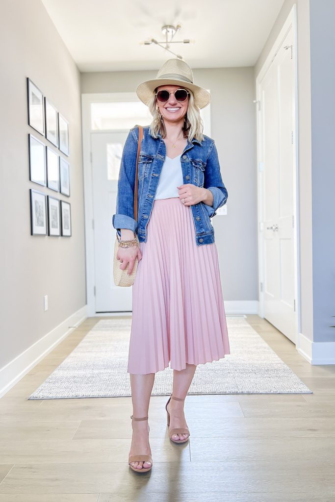 Pink pleated skirt with denim jacket to wear on a girls trip.