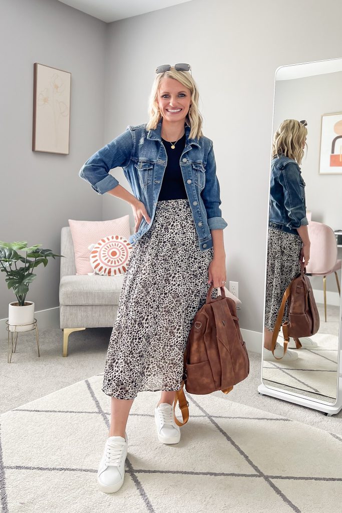 Leopard pleated skirt with a denim jacket and white sneakers.