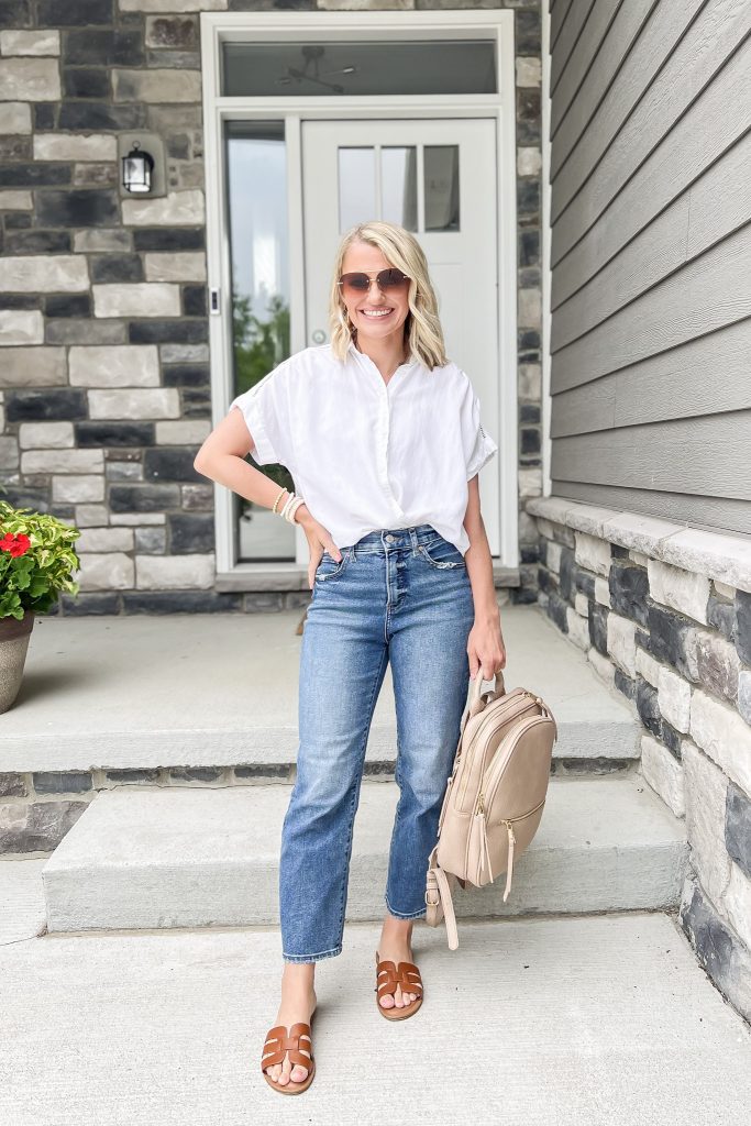 Cute mom outfit idea with jeans and a white short sleeve button down shirt. 