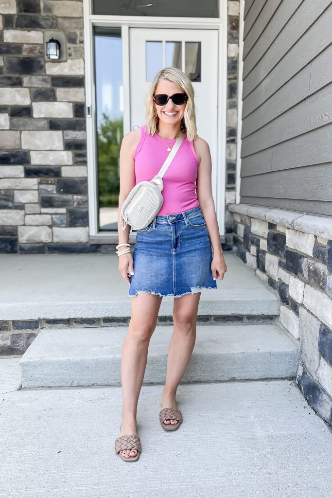 Cute mom outfit idea with a jean skirt and pink tank top.