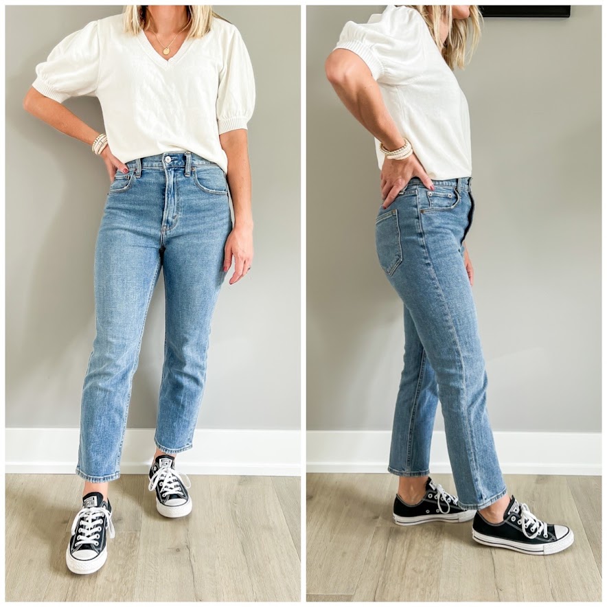 Black converse sneakers paired with straight-leg jeans. 