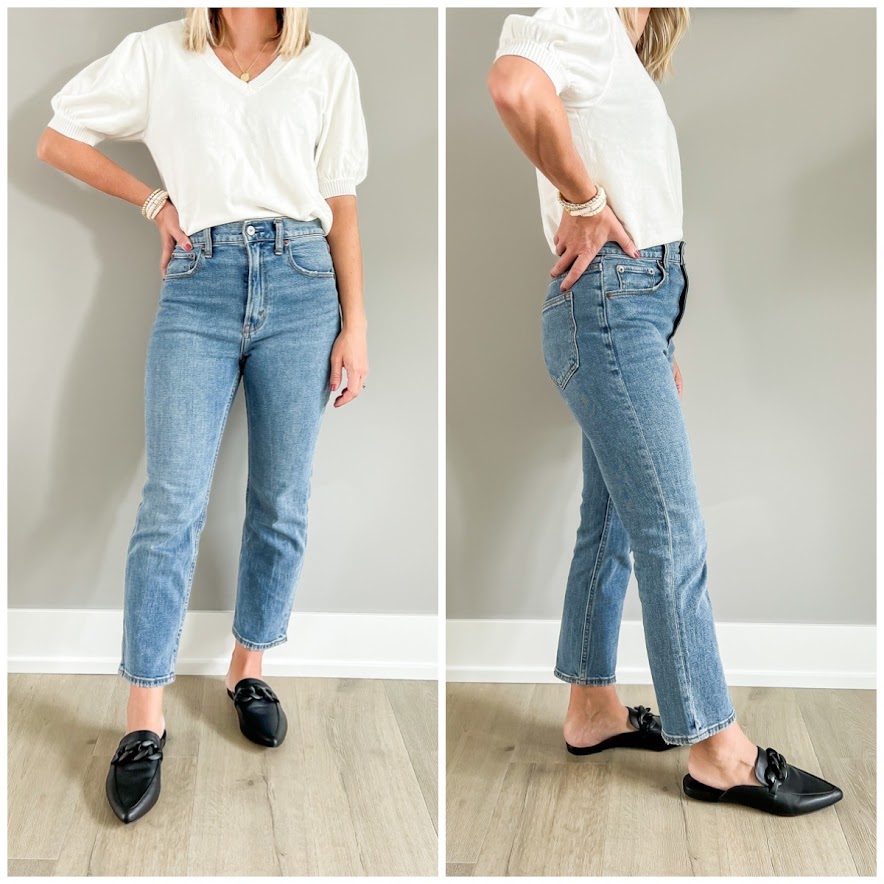 Black mules styled with straight-leg jeans.