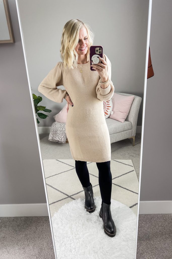 Chelsea boots styled with black opaque tights and a sweater dress. 