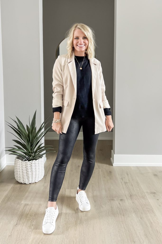 Black sweater with leggings and tan blazer. 