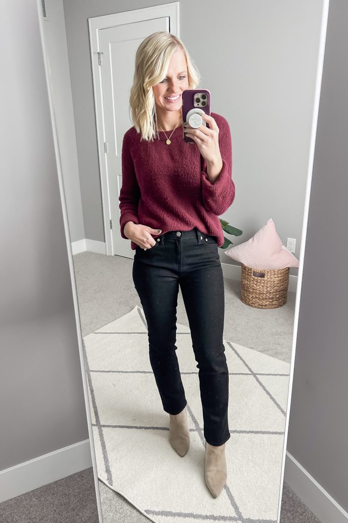 Maroon sweater with black jeans.