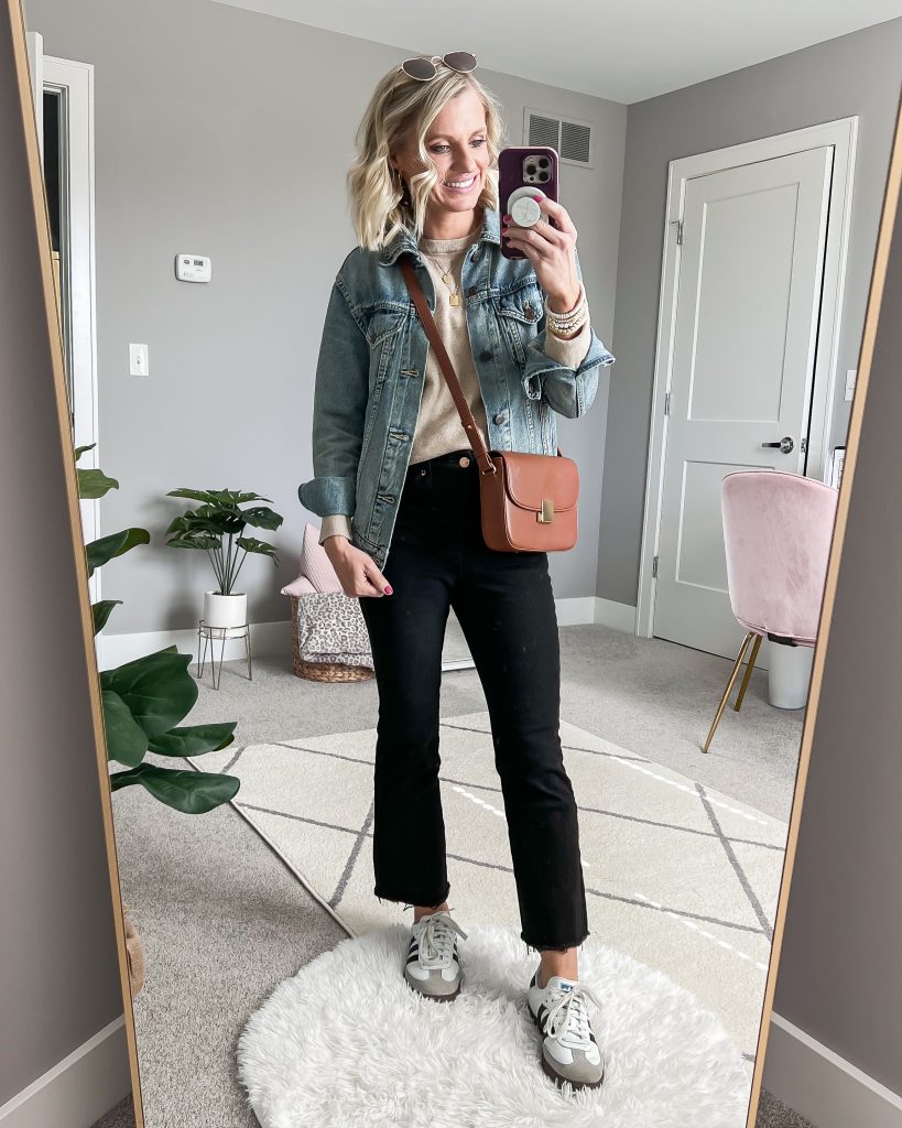 brown crossbody purse and denim jacket with black jeans