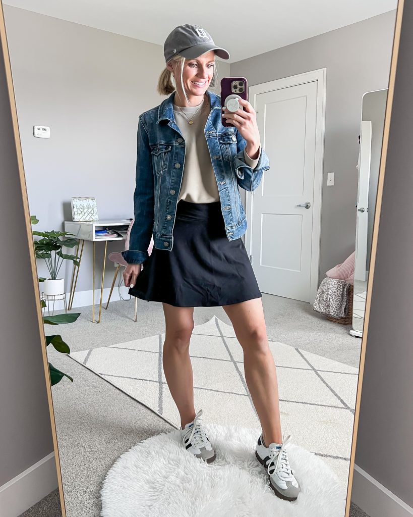 athletic skirt and jean jacket with baseball cap