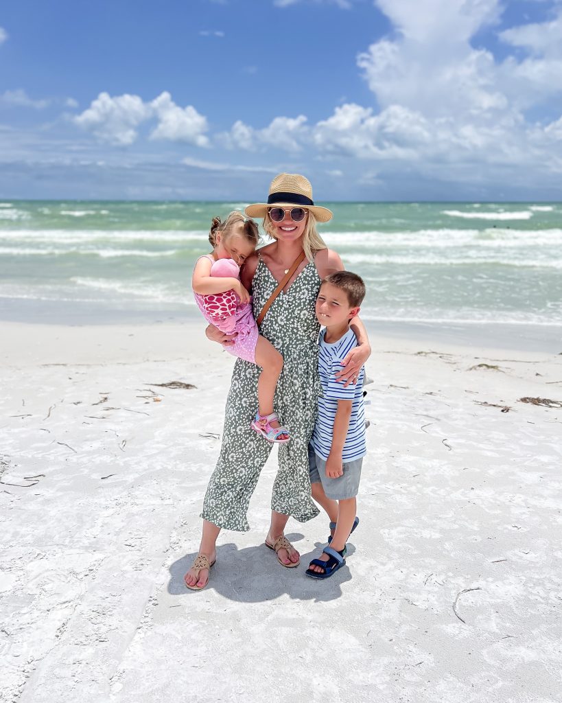 Green jumpsuit with kids at the beach