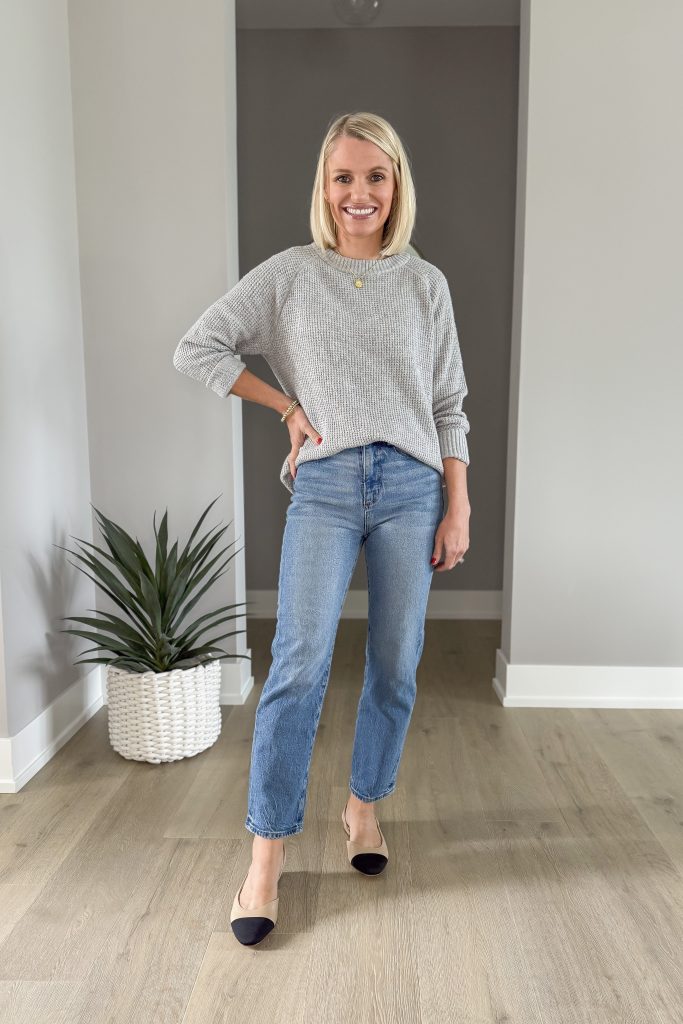 Gray sweater with straight leg jeans. 