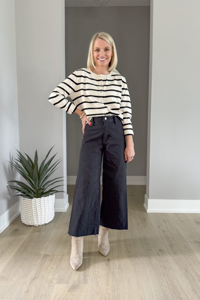 Striped sweater paired with black wide-leg cropped jeans and booties for winter. 