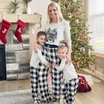 Mother and children in matching Christmas pajamas.