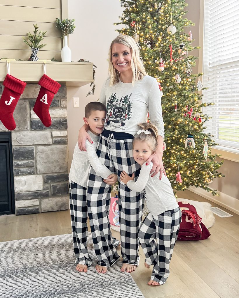 Mother and children in matching Christmas pajamas. 