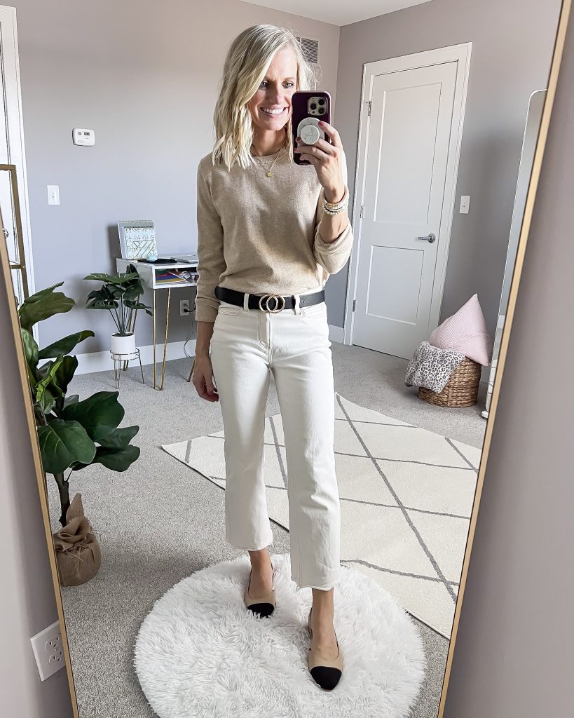 White Paige jeans paired with a tan sweater.