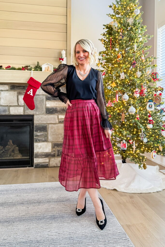 holiday party outfits red plaid midi skirt and black blouse